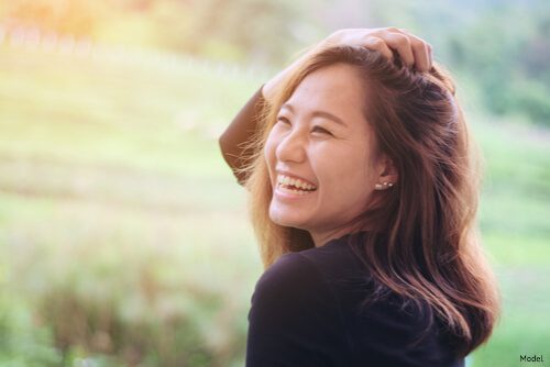 woman smiling into the sunlight
