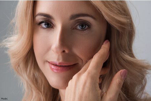 skin care institute june 2020 tulsa ok blog 4 skin care institute - woman gently touching her smooth her on her face