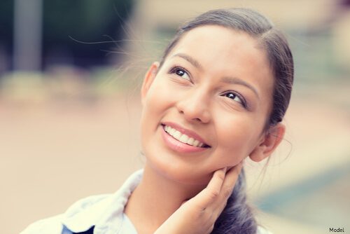 woman looking up at the sky smiling