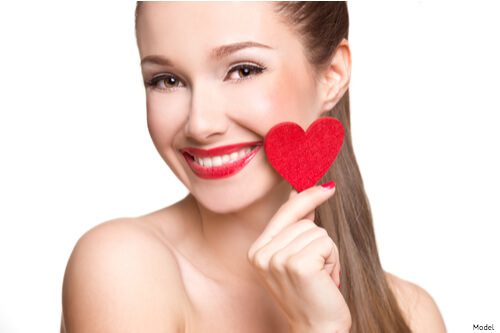 woman holding a paper heart