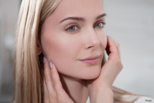 woman touching her face